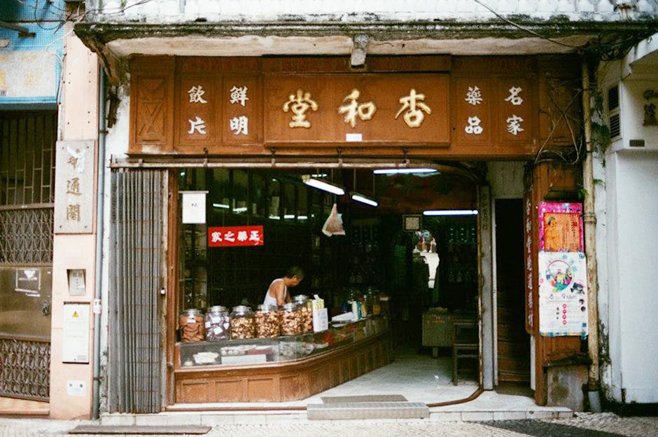 A traditional herbal shop facade with jars in Historic Macau. Oriental architecture and rich heritage.