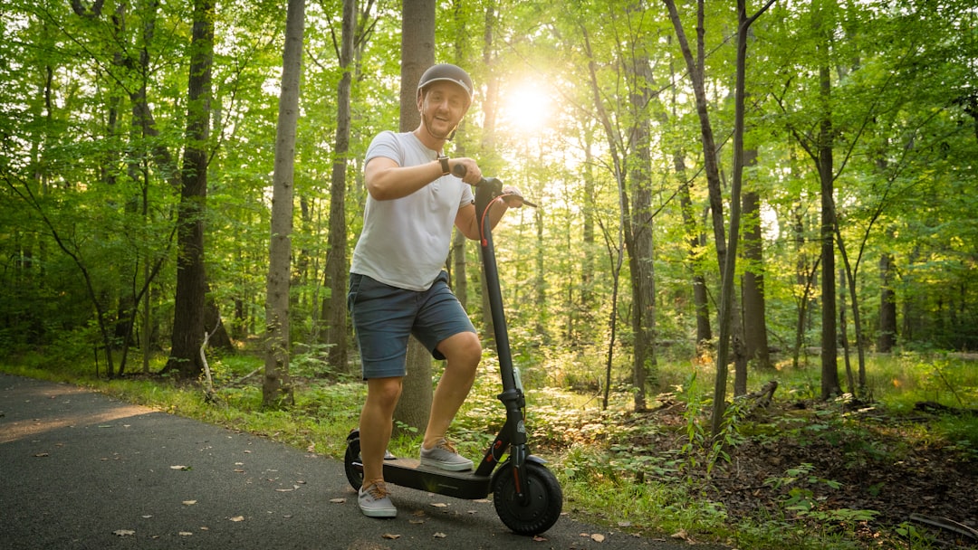 a man riding a scooter in the middle of a forest