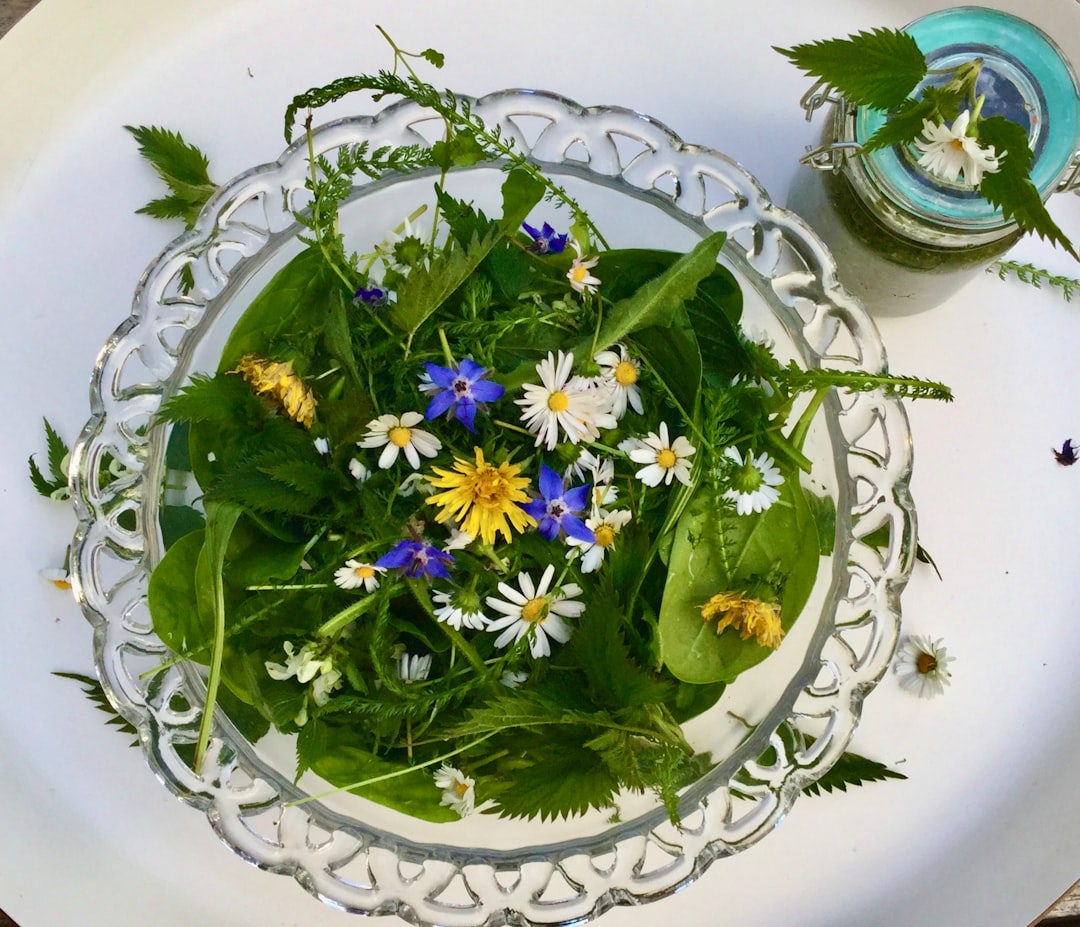 purple and yellow flowers on white ceramic round plate