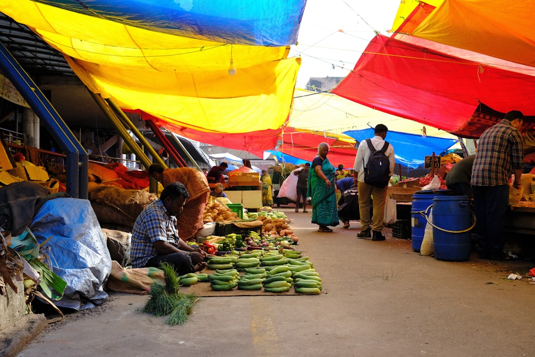 a group of people shopping at an outdoor market