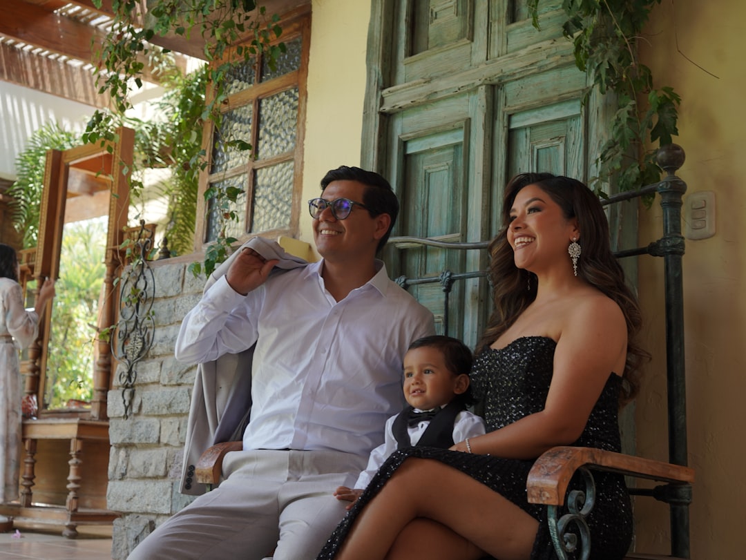 Family posing together outside their home.