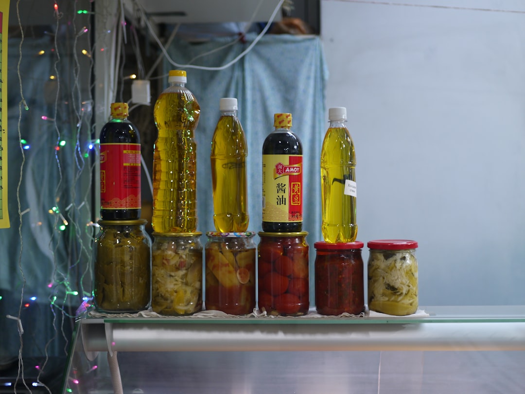 Bottles of oil and jars of food stacked