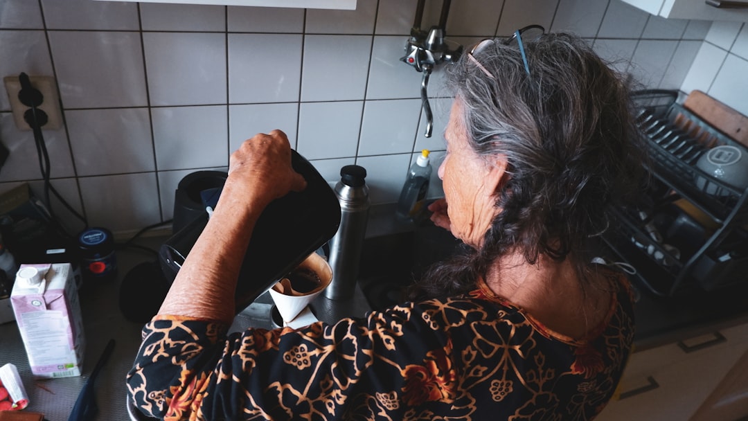 a person with long hair sitting in front of a stove