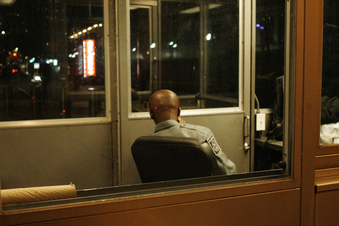 Man sitting in a security booth at night