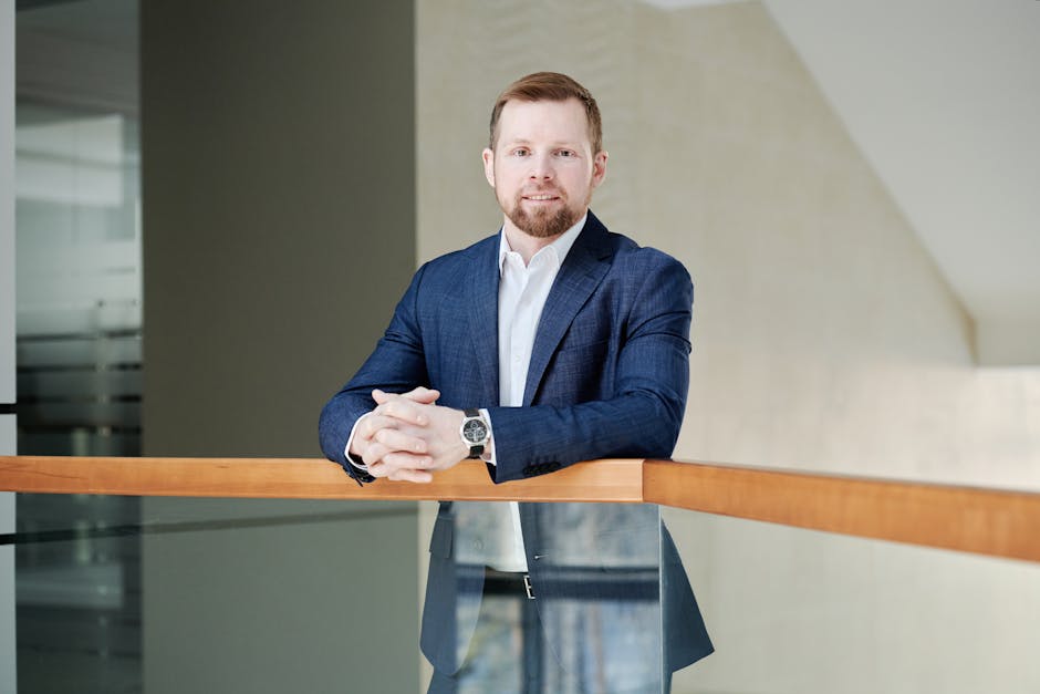 Professional man in a suit standing confidently indoors with natural light