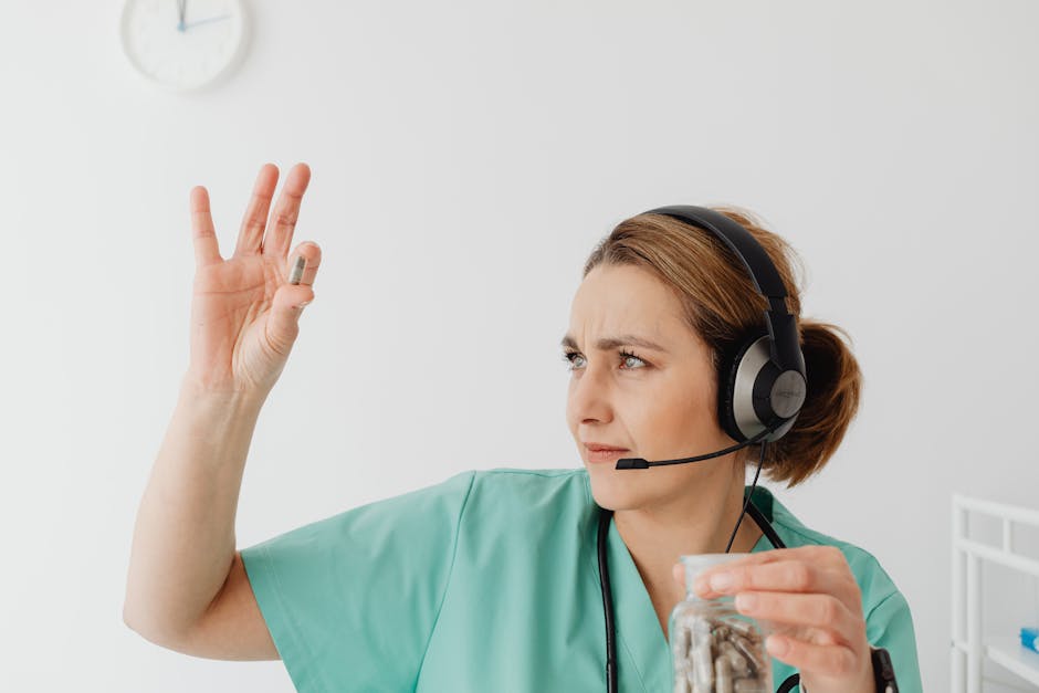 Female healthcare worker examines a capsule while wearing a headset, focusing on telemedicine.