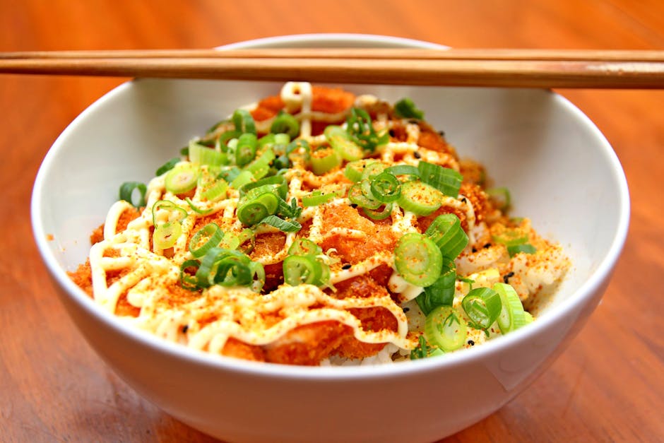 Delicious Japanese Tonkatsu bowl topped with fresh spring onions and mayo, ideal for lunch or dinner.