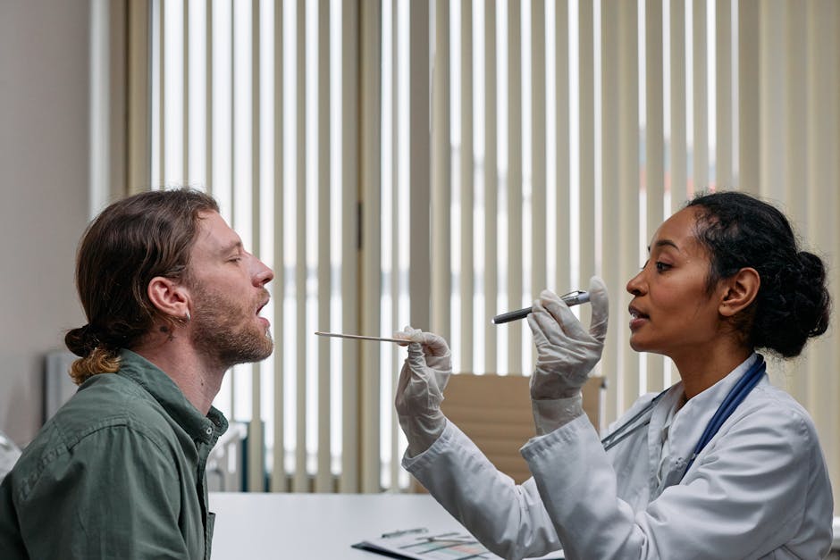 A doctor examining a patient's throat in a clinical setting, highlighting professional healthcare.