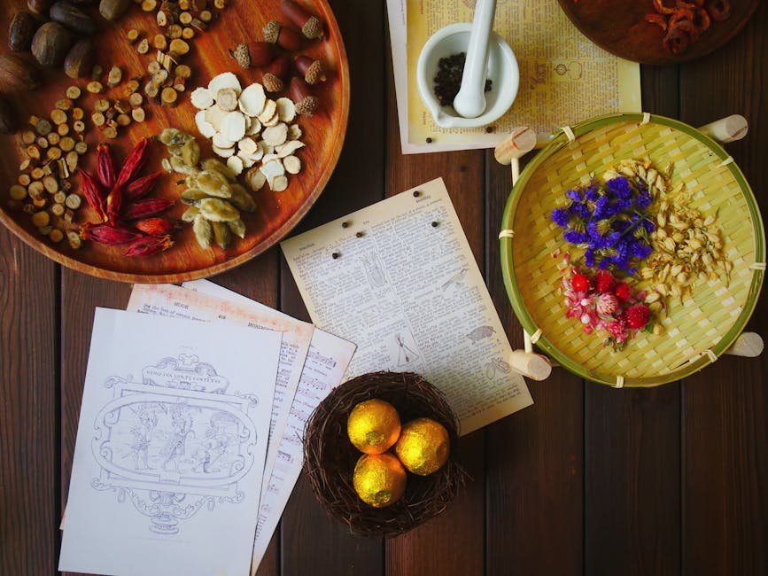 Overhead view of traditional herbs and ingredients for medicine making, featuring a ceramic mortar and vibrant dried flowers.